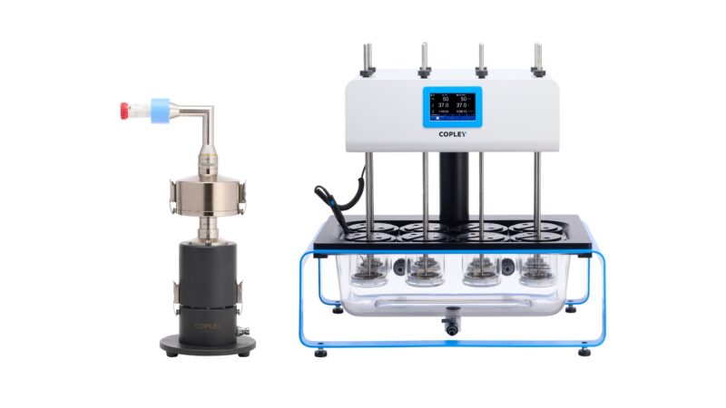 Copley Scientific Inhaled Dissolution Apparatus (IDA) positioned to the left assembled with a Preseparator, NGI induction port, dry powder inhaler (DPI) mouthpiece and a DPI on top of the IDA. To the right is a Copley Dissolution Tester (DIS-800i-ID) adapted for the IDA with flat-bottom vessels and purpose-built paddles, complimentary to the IDA filter holder.